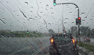 Rain Drop Falling On Car Windshield, Drive Car On Street In City hujan deres bigstock e1627862966618 1