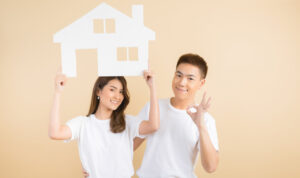 Young happy Asian couple presenting the symbols of house rsz young happy asian couple presenting symbols house